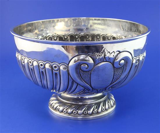 A late Victorian demi-spiral fluted silver presentation rose bowl by Goldsmiths & Silversmiths Co Ltd, 26 oz.